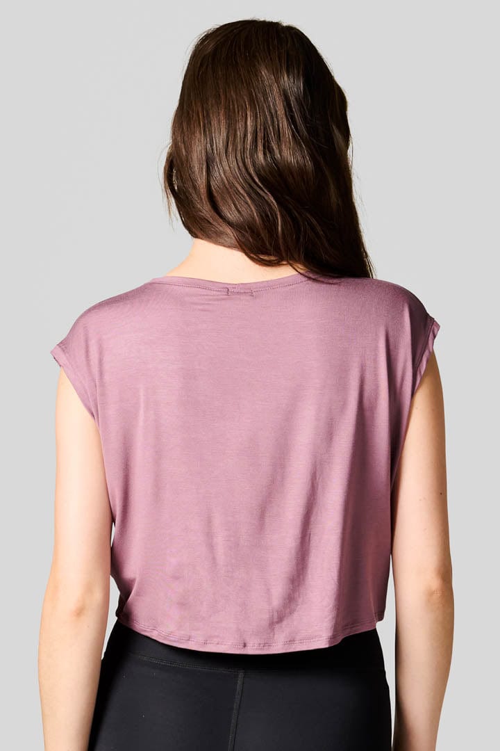 Back of a woman wearing a pink tee