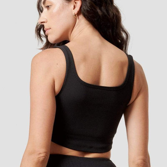 The back of a woman wearing a black reversible top. 