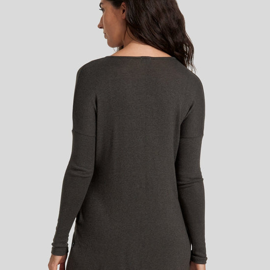 The back of a woman wearing a green sweater.