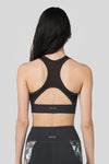 Back of a women wearing a Charcoal colour sports bra.