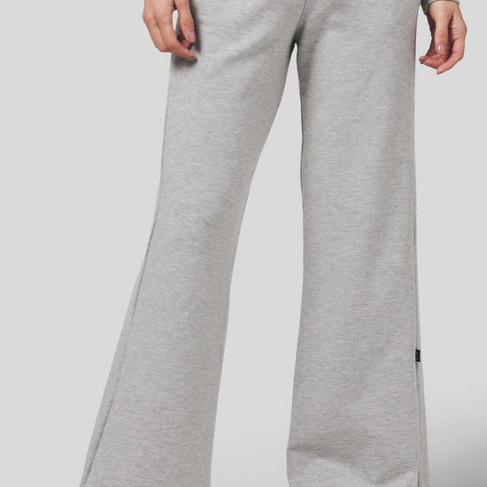 Women wearing a wide leg sweatpants in light heather grey