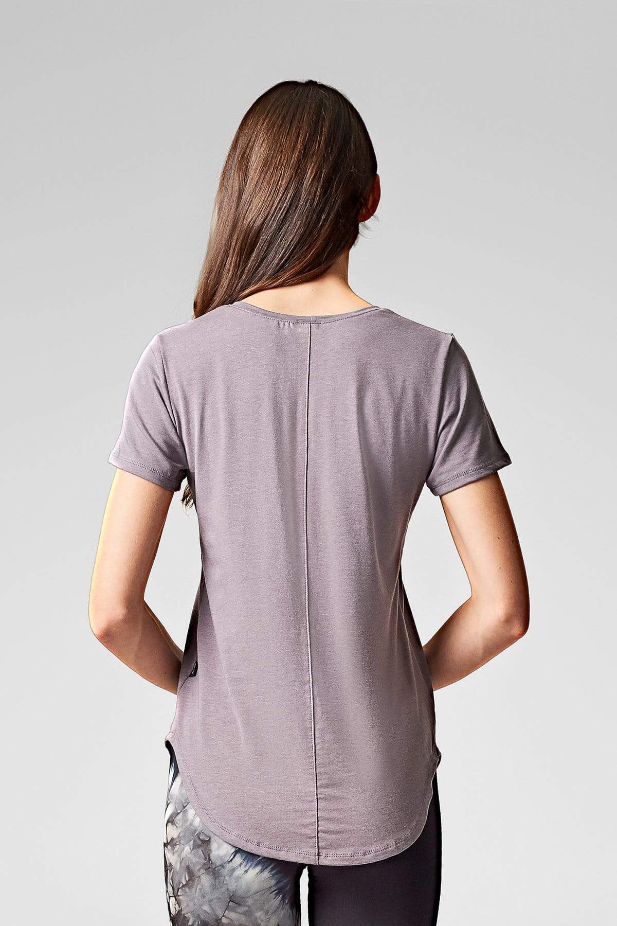 A brunette wears a grey t-shirt with baseball hem & short sleeves in tencel & organic cotton.
