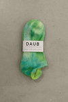 Hand dyed grip socks in Lime placed vertically