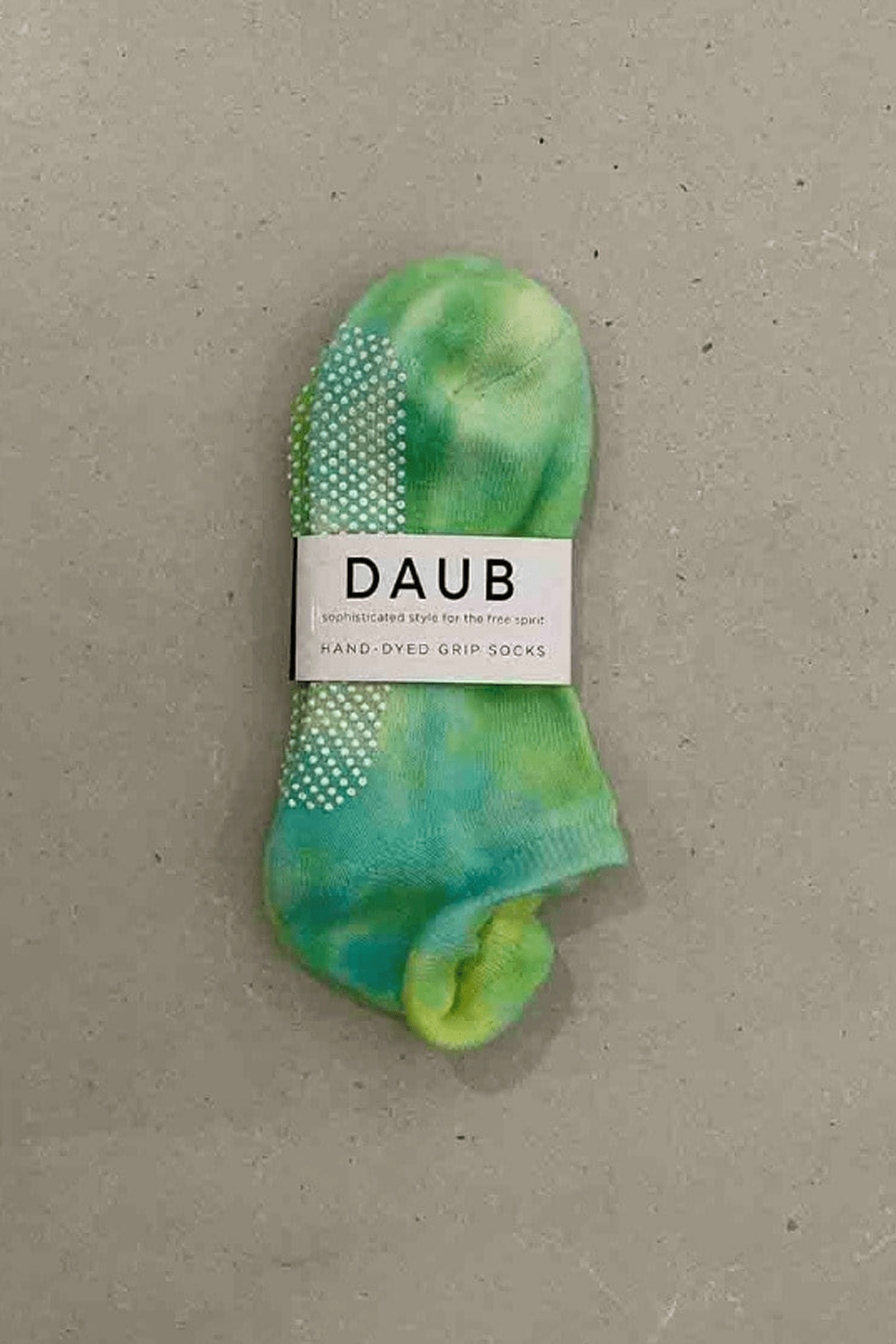 Hand dyed grip socks in Lime placed vertically