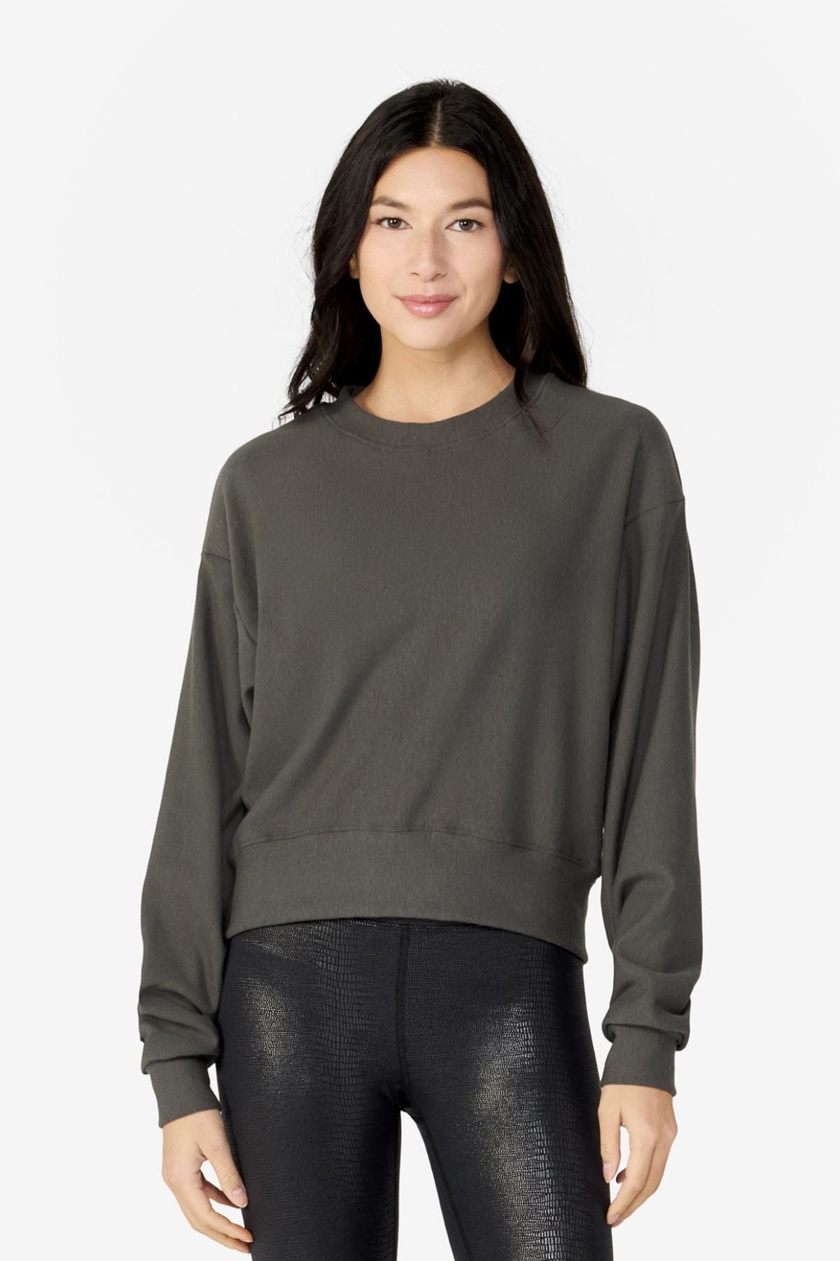 girl facing front wearing a dark green long sleeves sweater