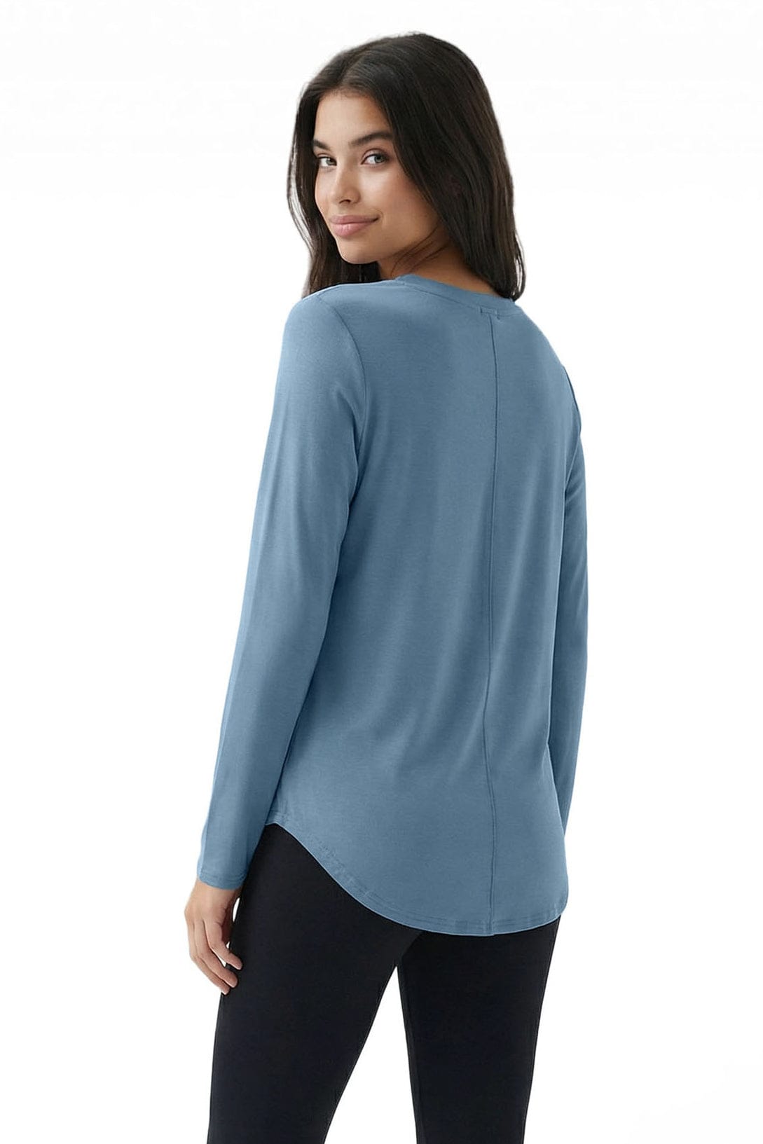 Woman wearing a blue long-sleeve top on a white background