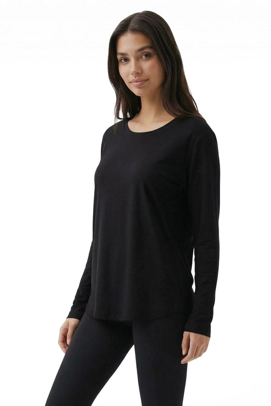 Woman wearing a black long-sleeve top on a white background