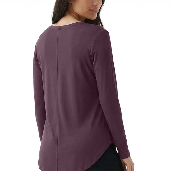 Woman wearing a purple long-sleeve top on a white background