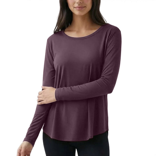 Woman wearing a purple long-sleeve top on a white background