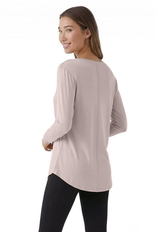 Woman wearing a light pink long-sleeve top on a white background