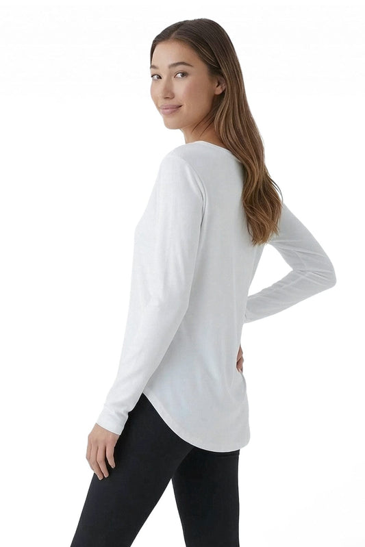 Woman wearing a white long-sleeve top and black pants on a white background