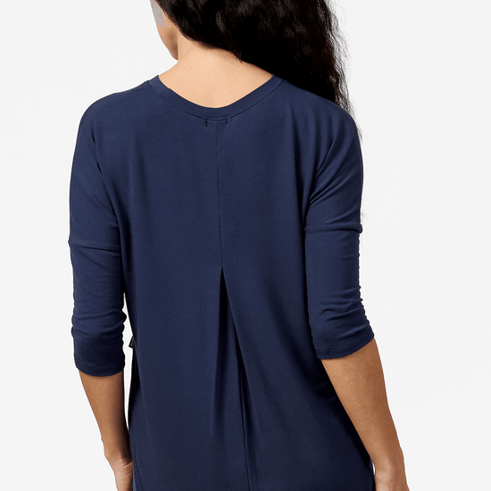 Back of a woman wearing a navy 3/4 length sleeve shirt