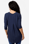Back of a woman wearing a navy 3/4 length sleeve shirt