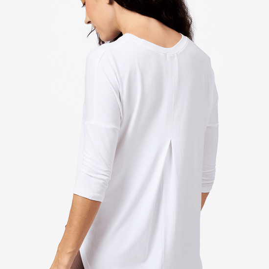 Back of a woman wearing a white 3/4 length sleeve shirt