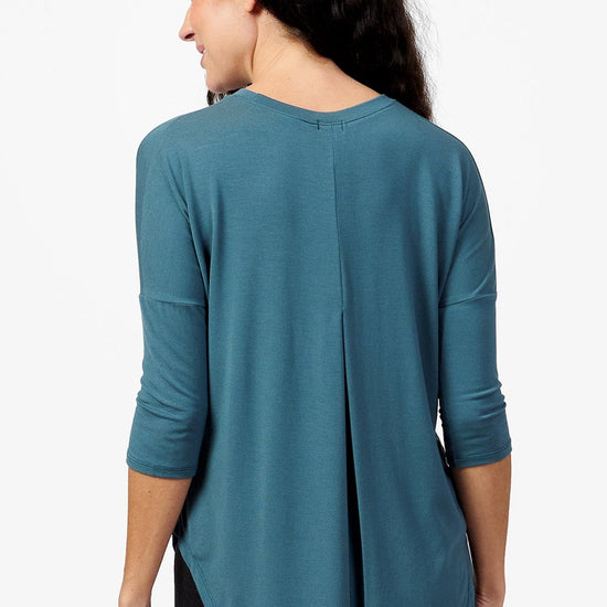 Back of a woman wearing a Teal 3/4 length sleeve shirt
