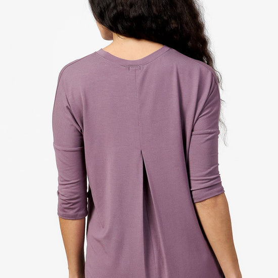 back of a woman wearing a light purple 3/4 length sleeve shirt