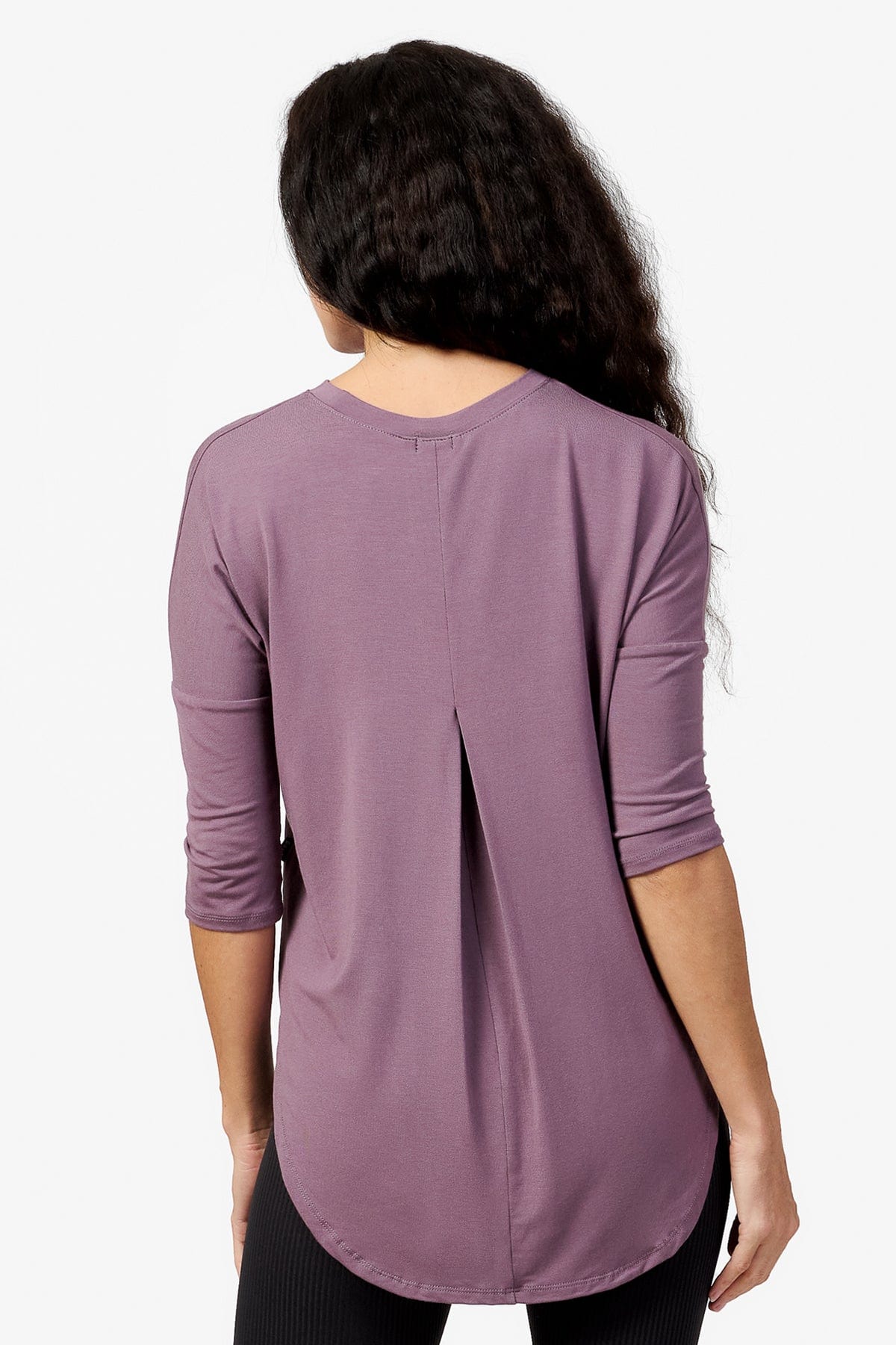 back of a woman wearing a light purple 3/4 length sleeve shirt