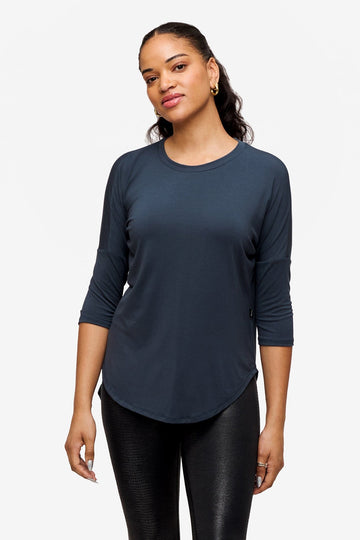 Woman wearing a dark blue 3/4 sleeve shirt