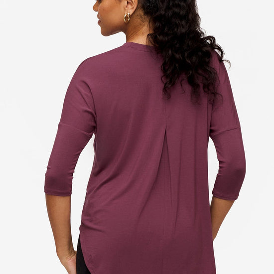 back of a woman wearing a deep pink 3/4 sleeve shirt