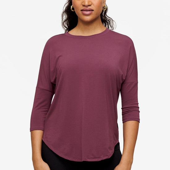 Woman wearing a deep pink 3/4 sleeve shirt