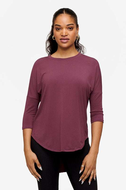 Woman wearing a deep pink 3/4 sleeve shirt