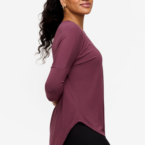 Side of a Woman wearing a deep pink 3/4 sleeve shirt