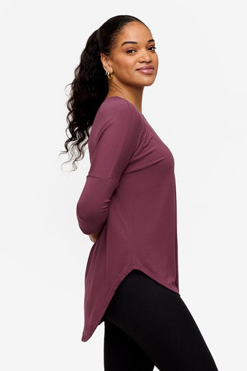 Side of a Woman wearing a deep pink 3/4 sleeve shirt