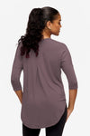 back of a woman wearing a 3/4 sleeve shirt in purple