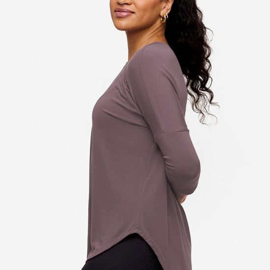 woman wearing a 3/4 sleeve shirt in purple