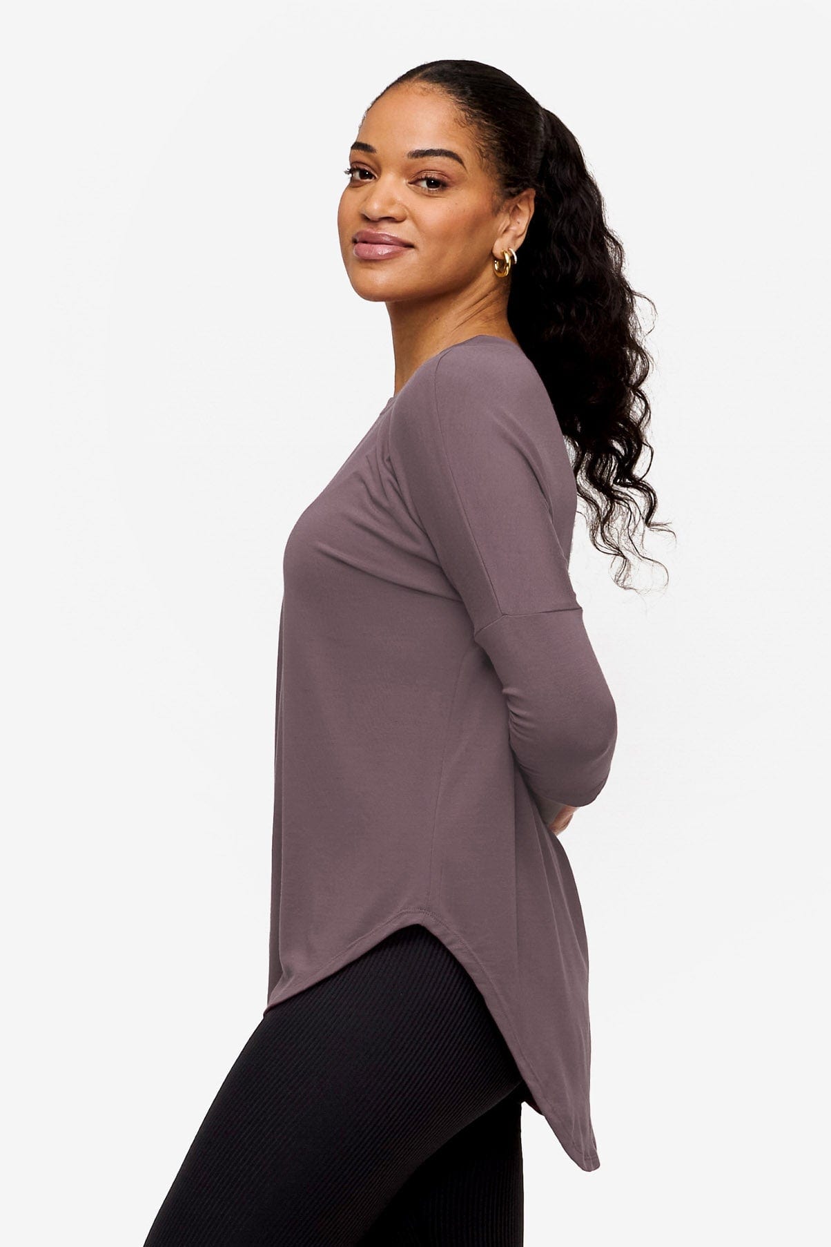 woman wearing a 3/4 sleeve shirt in purple