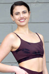 Woman smiling and wearing a Swimsuit top that is tie-dye