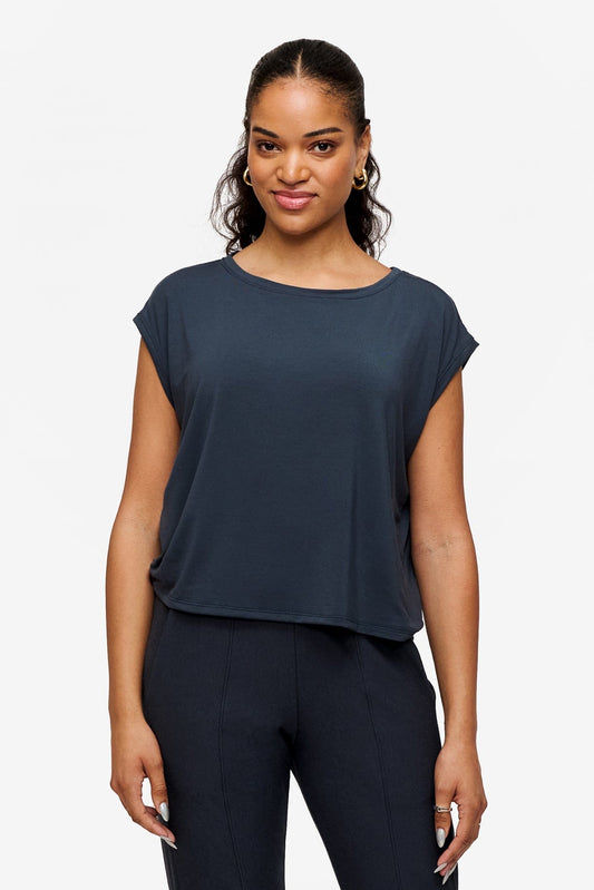 Woman wearing a sleeveless top in dark blue