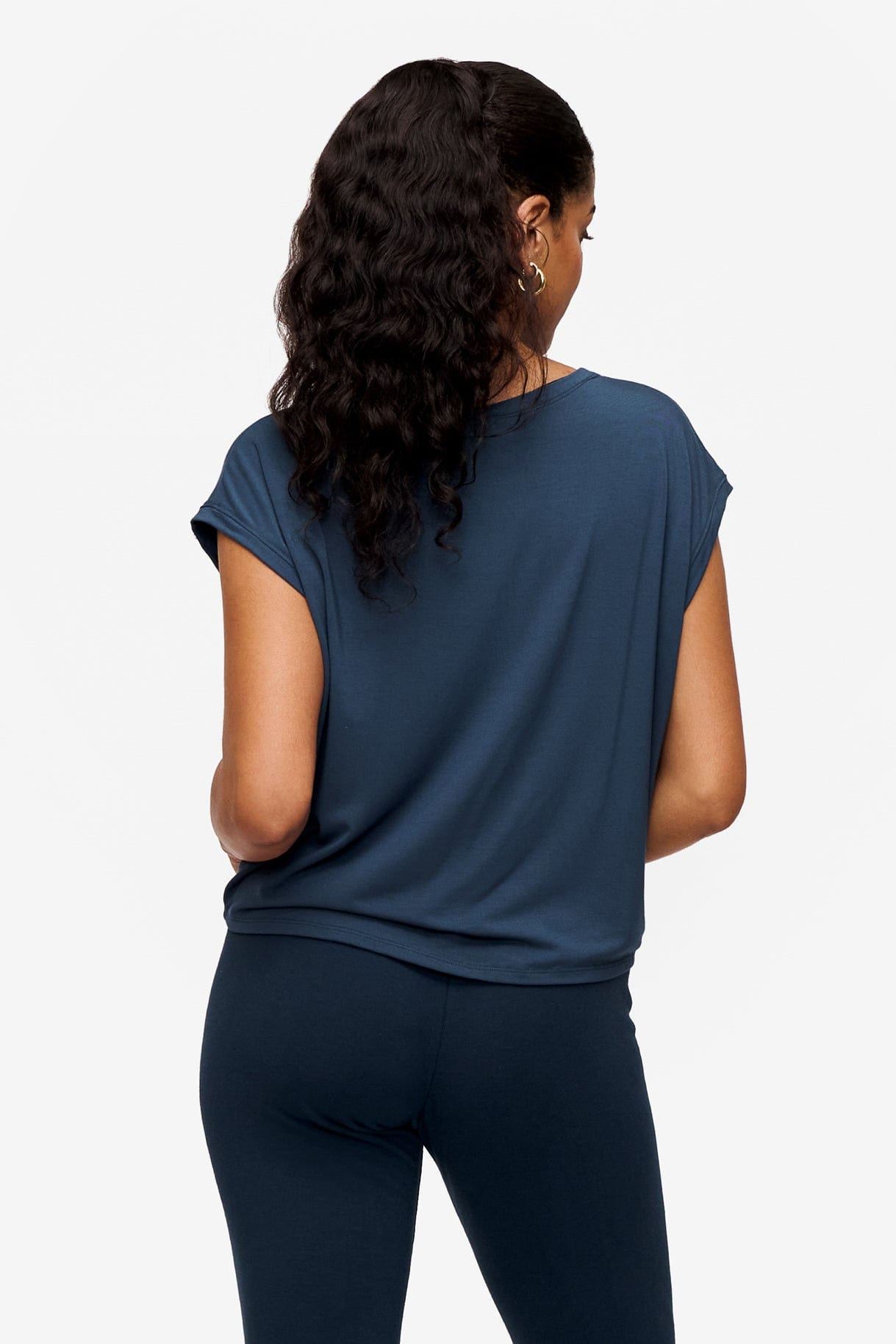 back of a woman wearing a sleeveless top in bright blue