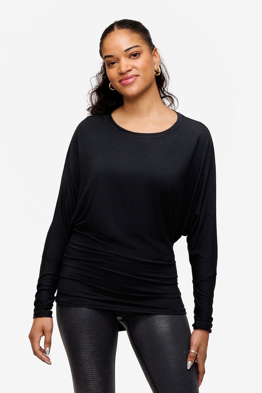 woman wearing a black loose dolman sleeve long sleeve shirt