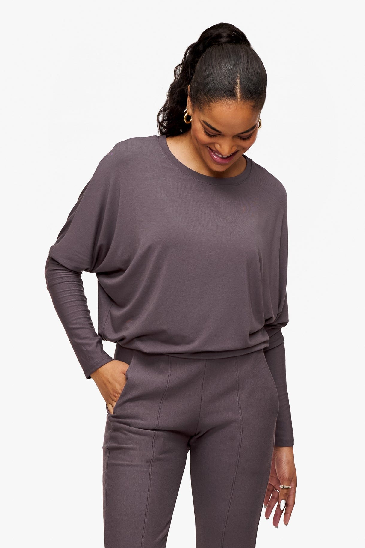 looking down a woman is wearing a deep purple loose sleeve long sleeve shirt