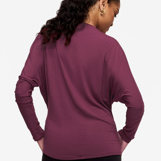 back of a woman wearing a pink long sleeve tee with dolman sleeves