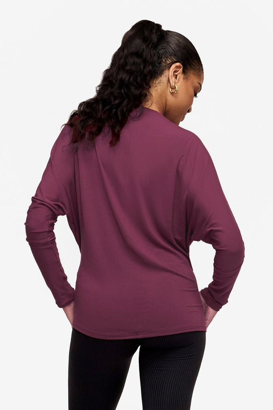 back of a woman wearing a pink long sleeve tee with dolman sleeves