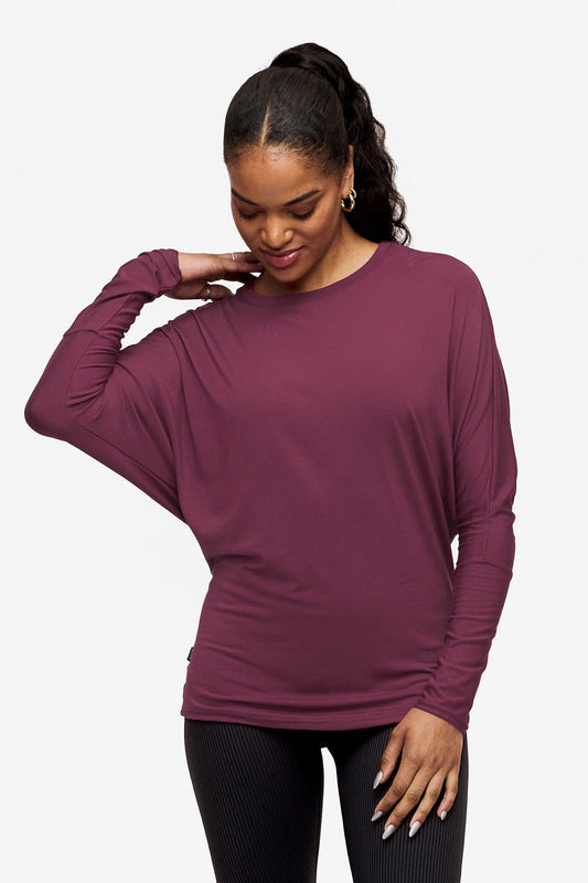 woman wearing a pink long sleeve tee with dolman sleeves