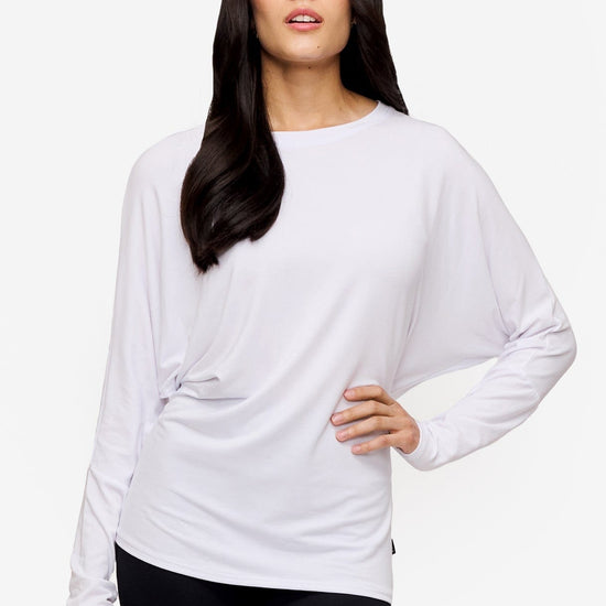 woman wearing a white loose sleeve long sleeve shirt