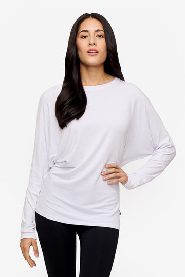 woman wearing a white loose sleeve long sleeve shirt