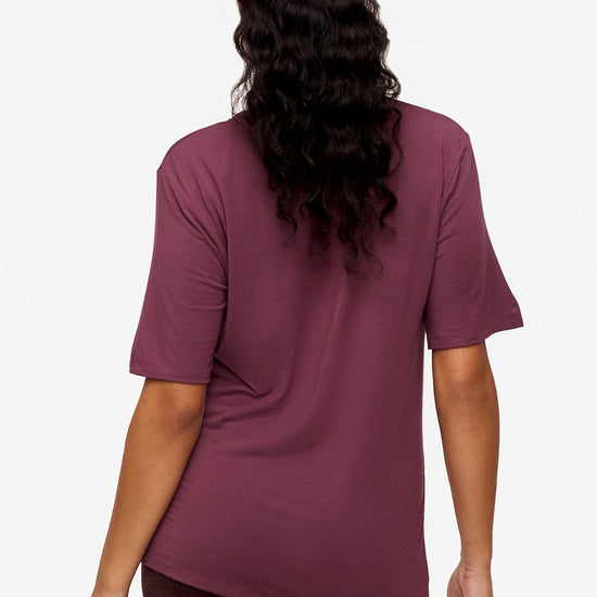 back of a woman wearing deep pink v-neck short sleeve t-shirt