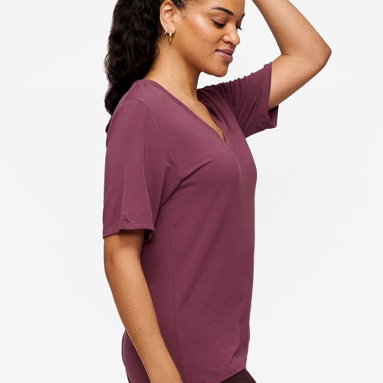 side of a woman wearing deep pink v-neck short sleeve t-shirt