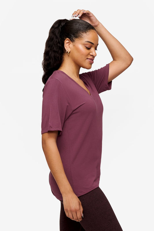 side of a woman wearing deep pink v-neck short sleeve t-shirt