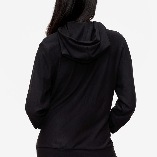 back of a woman wearing a black zipped hoodie