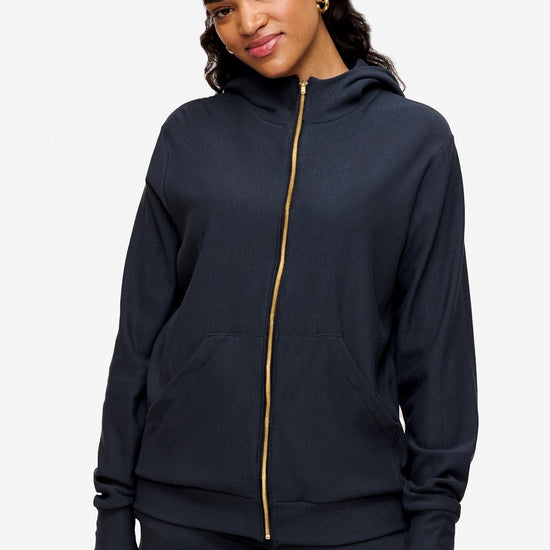 woman wearing full zip hoodie in dark blue 