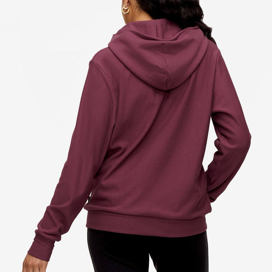 back of woman wearing full zip hoodie in deep pink
