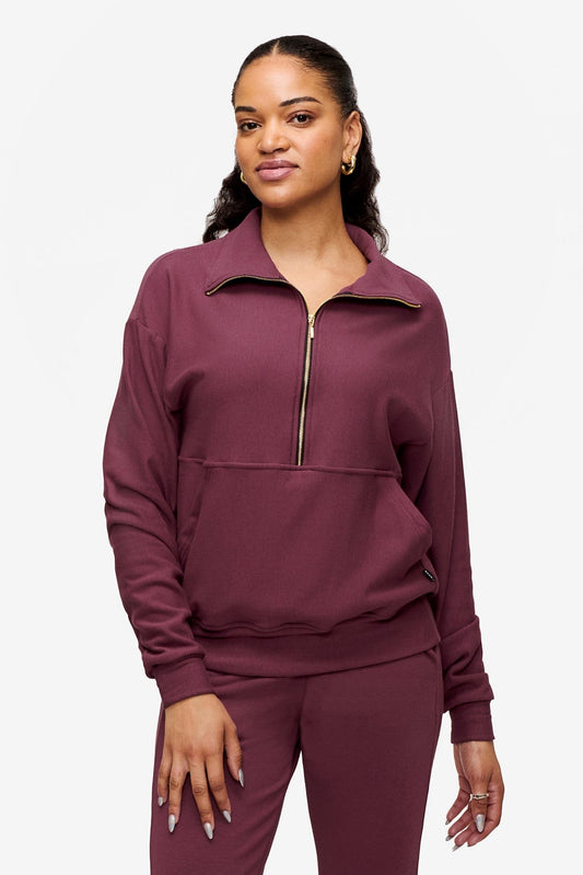 woman wearing half zip sweatshirt in deep pink