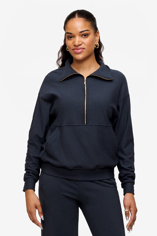 woman wearing half zip sweatshirt in dark blue 