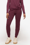 woman wearing deep pink sweatpants with drawstring  with matching top