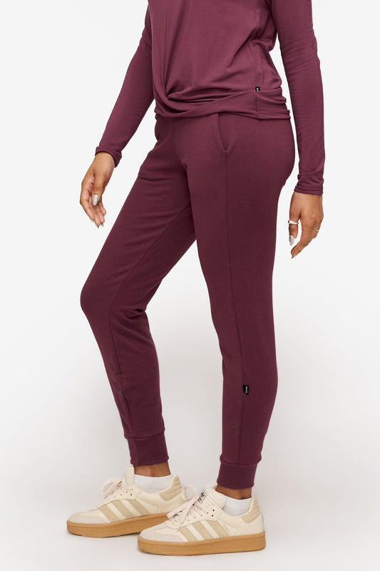 side of a woman wearing deep pink sweatpants with drawstring 